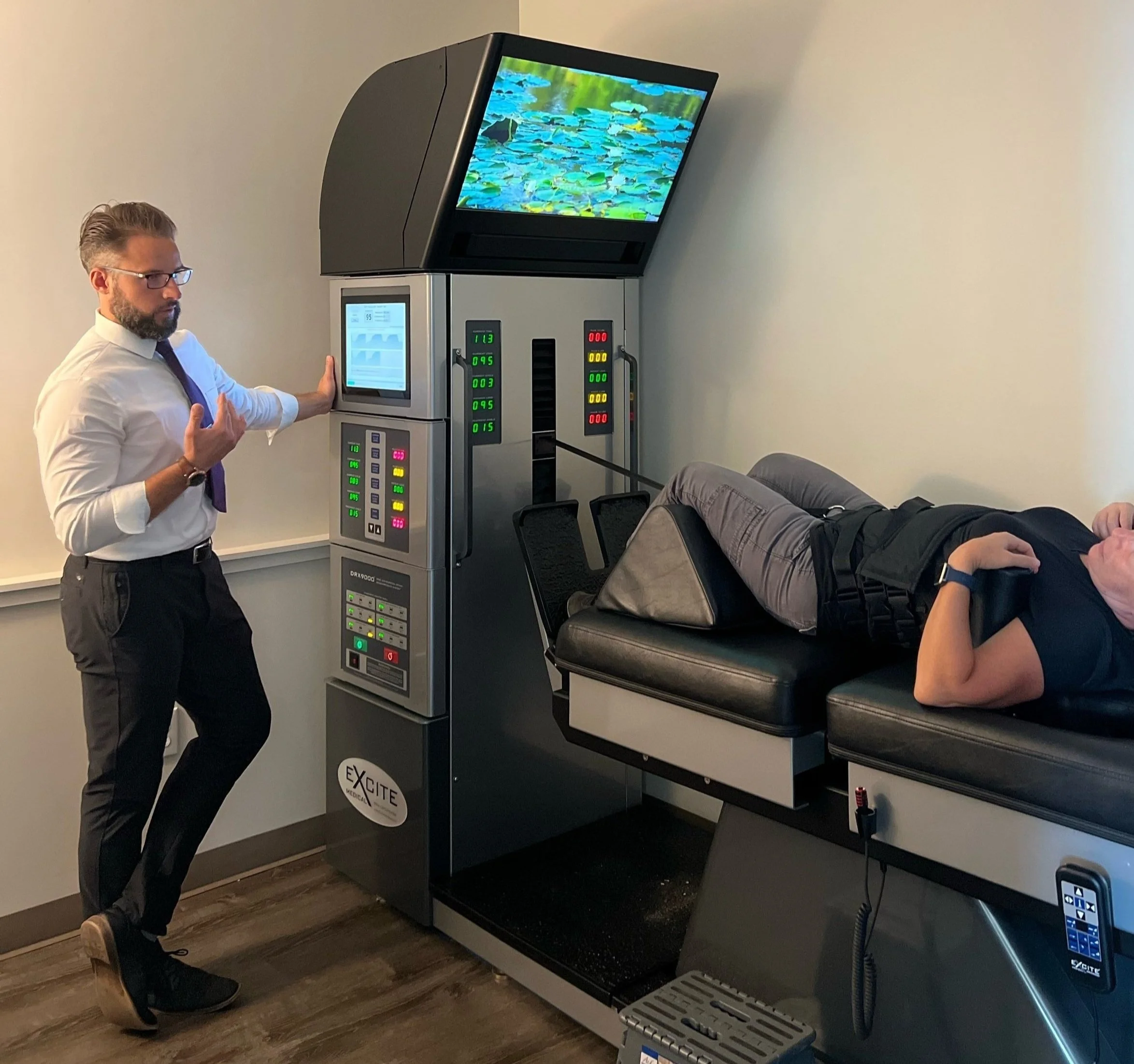Patient receiving non-surgical spinal decompression on a DRX9000 table at The Disc Doctors